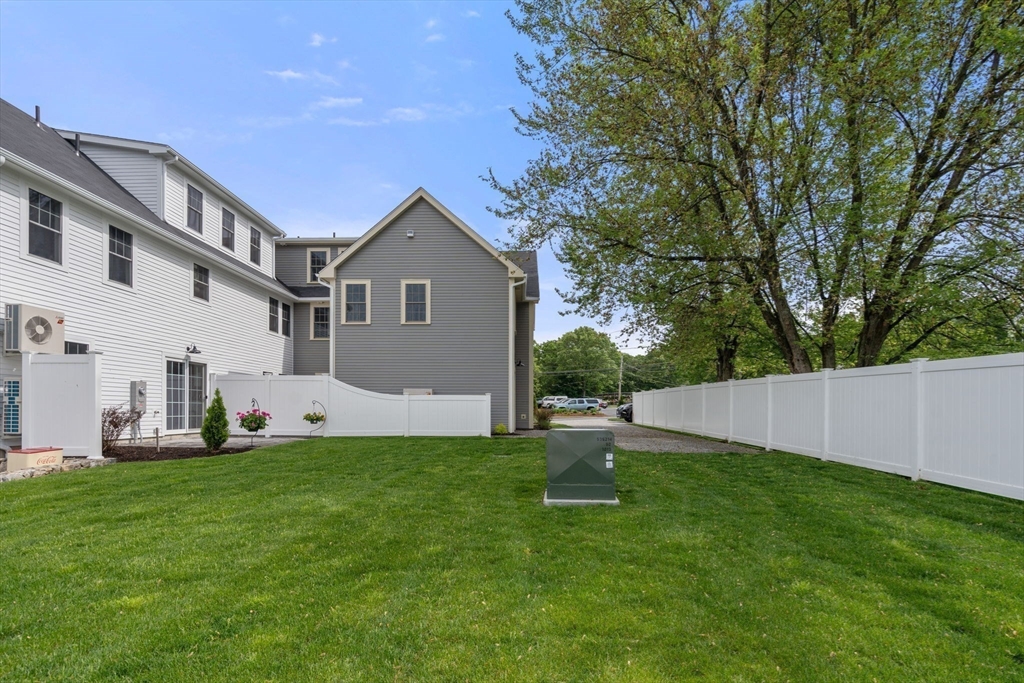 97 Bacon Street, Unit B Natick, MA 01760 - Photo 25 of 37 a view of a house with a yard and sitting area