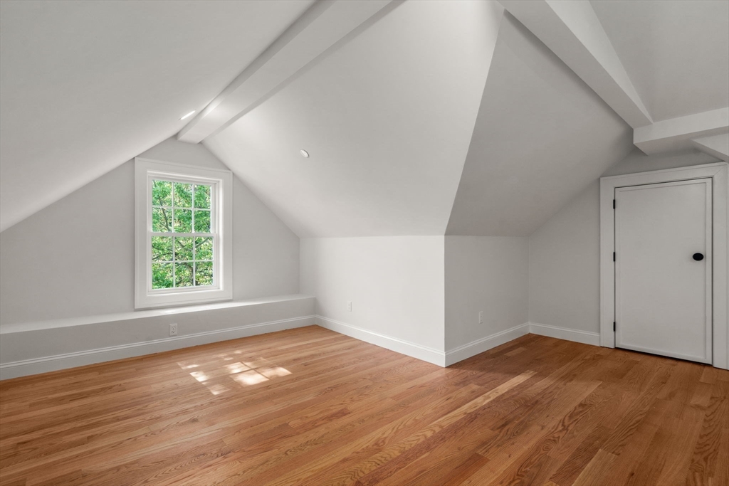 97 Bacon Street, Unit B Natick, MA 01760 - Photo 26 of 37 an empty room with wooden floor and windows