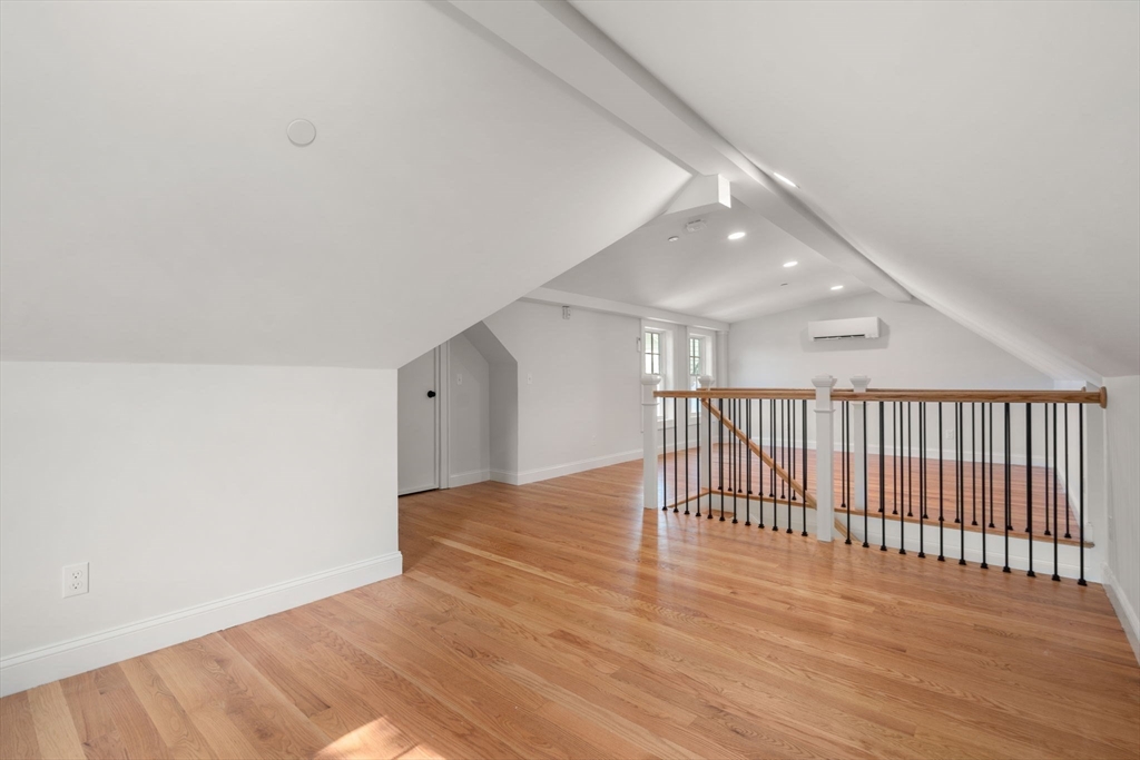 97 Bacon Street, Unit B Natick, MA 01760 - Photo 27 of 37 a view of an empty room with wooden floor