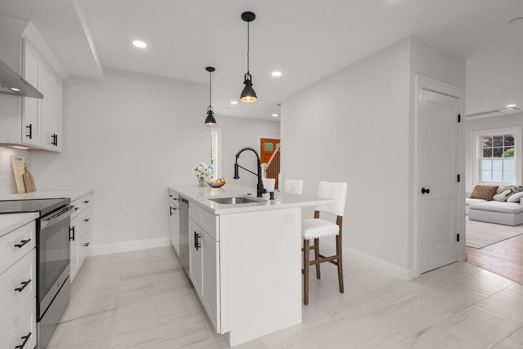 97 Bacon Street, Unit B Natick, MA 01760 - Photo 3 of 37 a kitchen with a sink and refrigerator