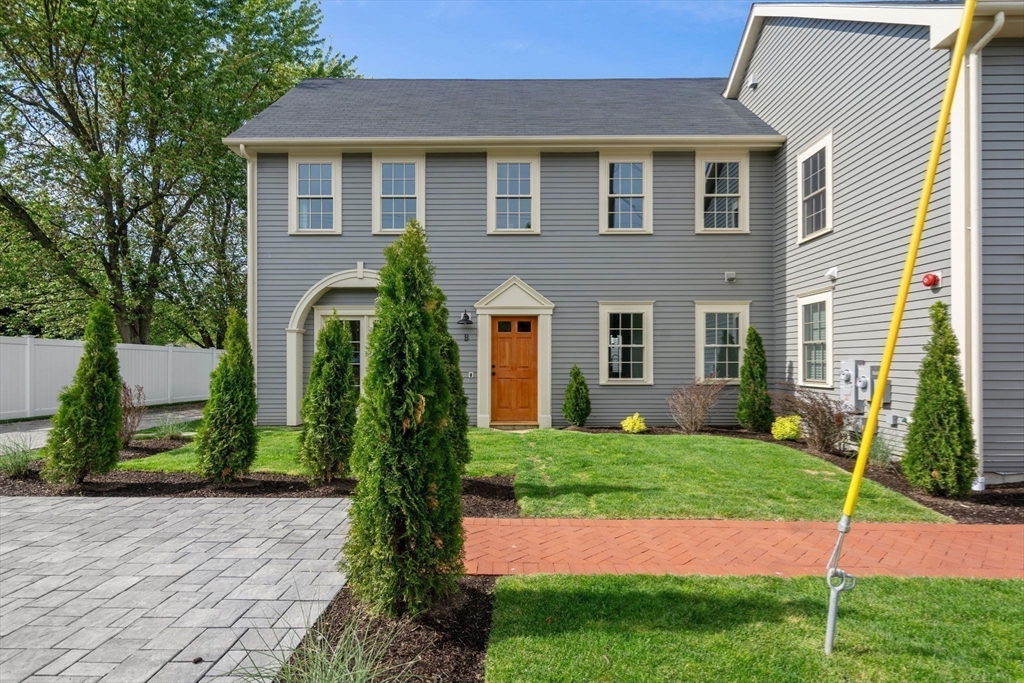 97 Bacon Street, Unit B Natick, MA 01760 - Photo 34 of 37 a front view of a house with garden