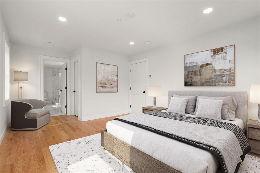 97 Bacon Street, Unit B Natick, MA 01760 - Photo 4 of 37 a bedroom with a large bed and a couch