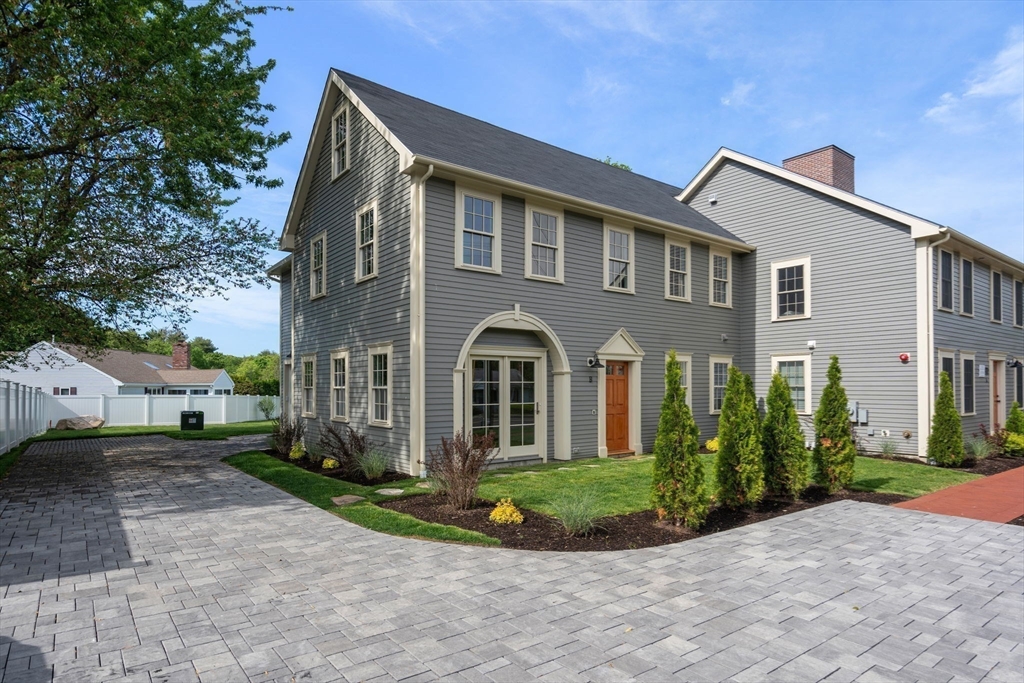 97 Bacon Street, Unit B Natick, MA 01760 - Photo 5 of 37 a front view of a house with a yard