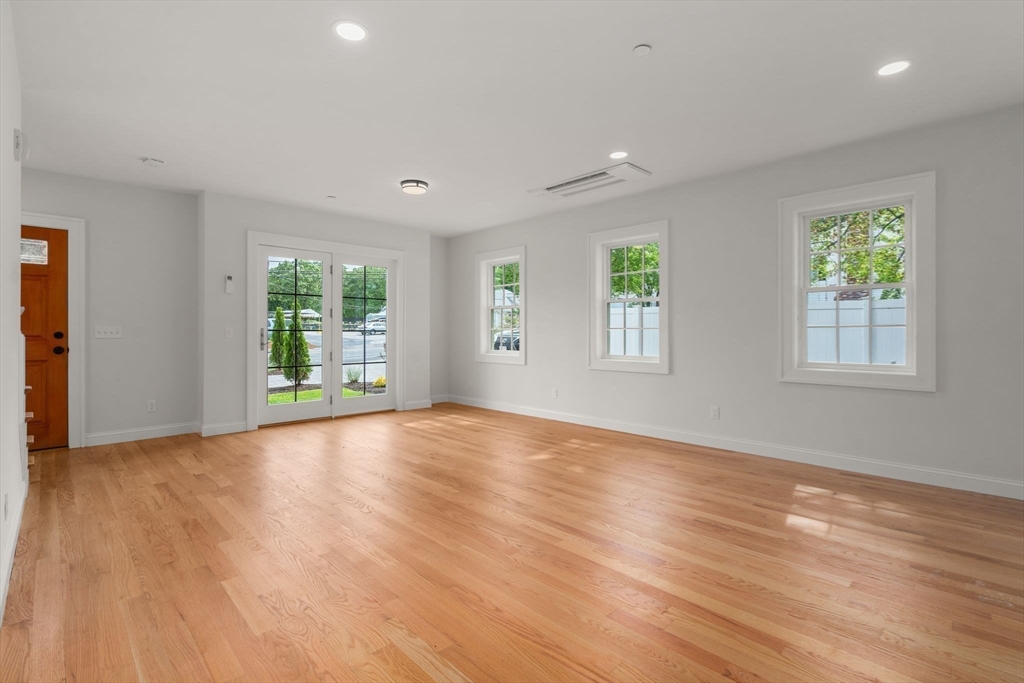 97 Bacon Street, Unit B Natick, MA 01760 - Photo 10 of 37 a view of an empty room with wooden floor and a window