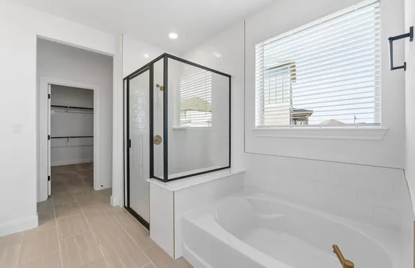 a spacious bathroom with a double vanity sink a mirror and a bathtub