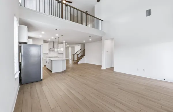 a view of kitchen and hall with wooden floor