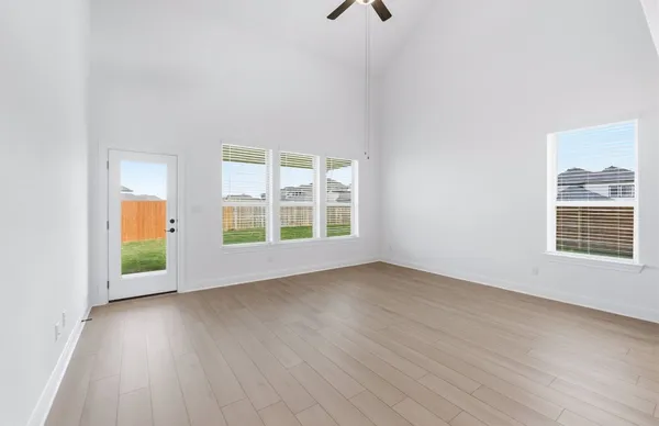 a kitchen with stainless steel appliances a refrigerator and a wooden floor
