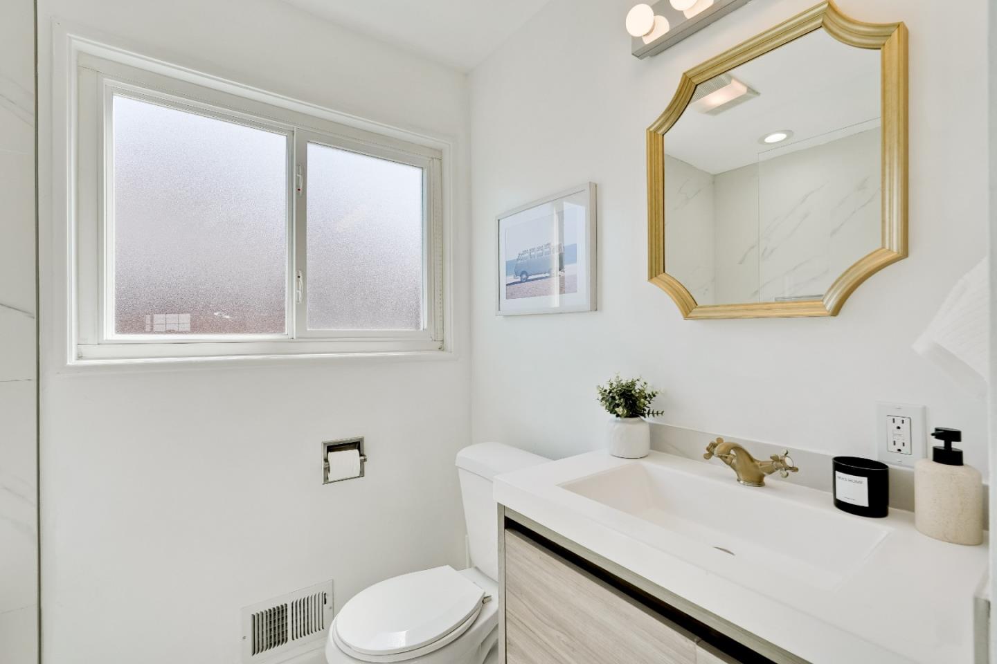 1755 Ravizza Avenue Santa Clara, CA 95051 - Photo 24 of 36 a bathroom with a granite countertop sink vanity mirror and toilet