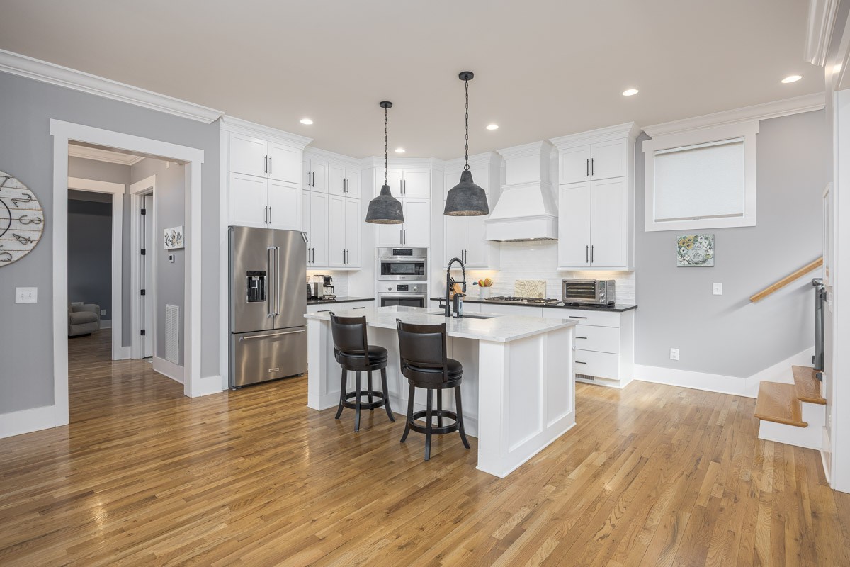 960 Cheltenham Avenue Franklin, TN 37064 - Photo 13 of 62 a kitchen with stainless steel appliances kitchen island granite countertop a refrigerator a stove a sink a dining table and chairs with wooden floor