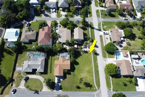 an aerial view of multiple houses with yard