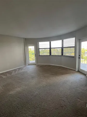 an empty room with windows and entrance