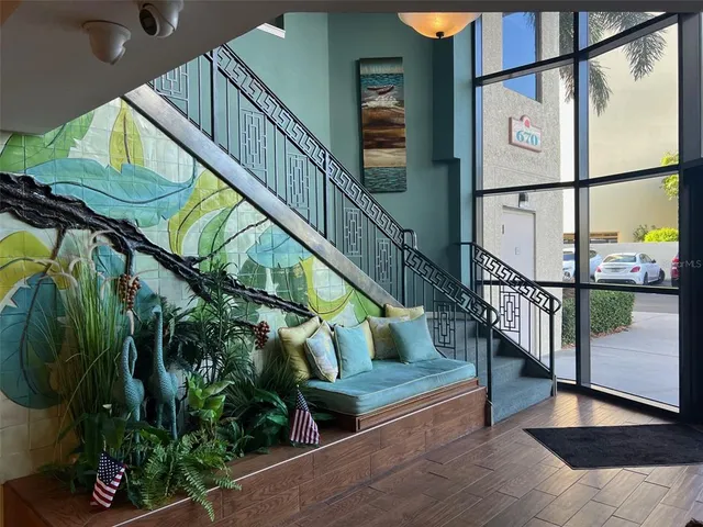 a living room with couch and a hard wood floor