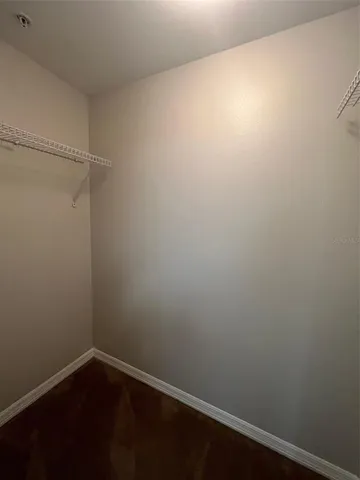 a living room with furniture kitchen view and a window