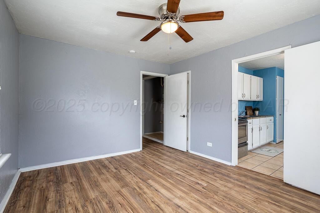 4105 Gables Street Amarillo, TX 79110 - Photo 12 of 18 a view of empty room with wooden floor and ceiling fan