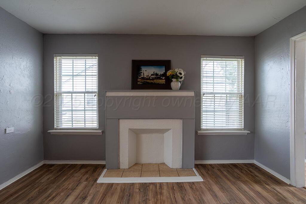 4105 Gables Street Amarillo, TX 79110 - Photo 3 of 18 a view of an empty room with wooden floor and a window
