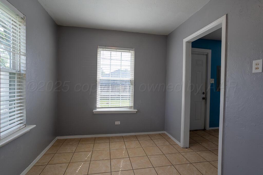 4105 Gables Street Amarillo, TX 79110 - Photo 5 of 18 an empty room that has a window in it