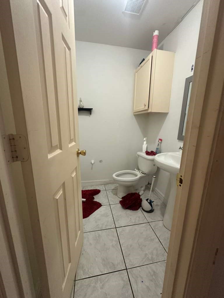 8404 Leander Street Houston, TX 77012 - Photo 12 of 28 a bathroom with a sink and a toilet