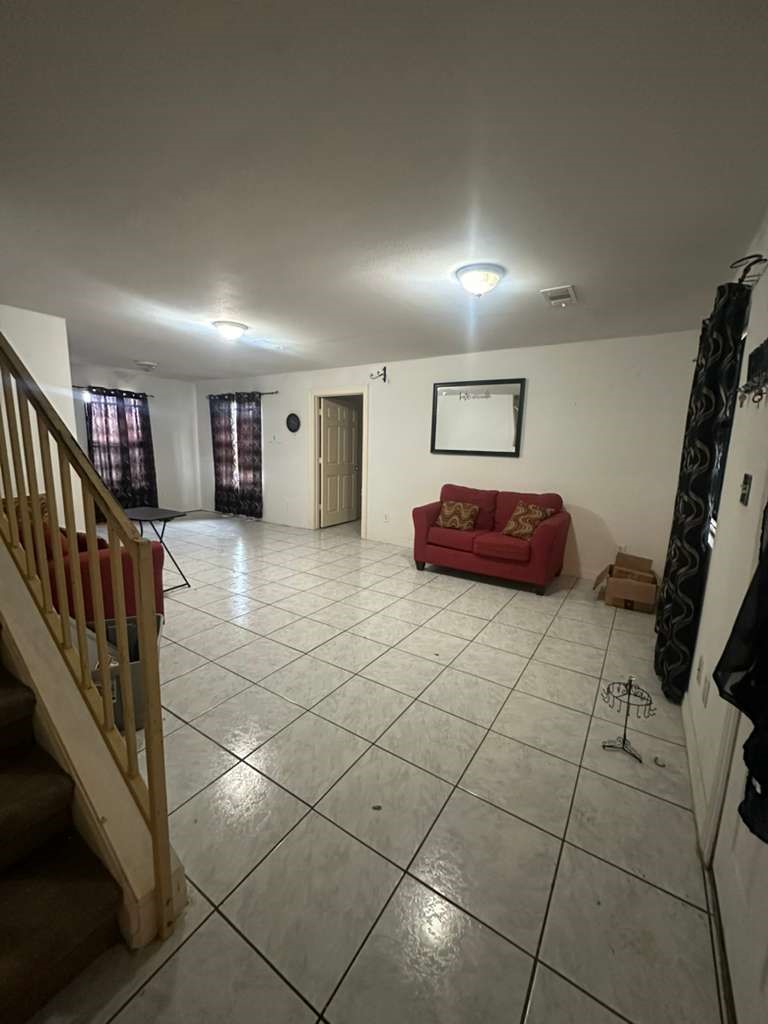 8404 Leander Street Houston, TX 77012 - Photo 4 of 28 a spacious bathroom with a tub and a large window