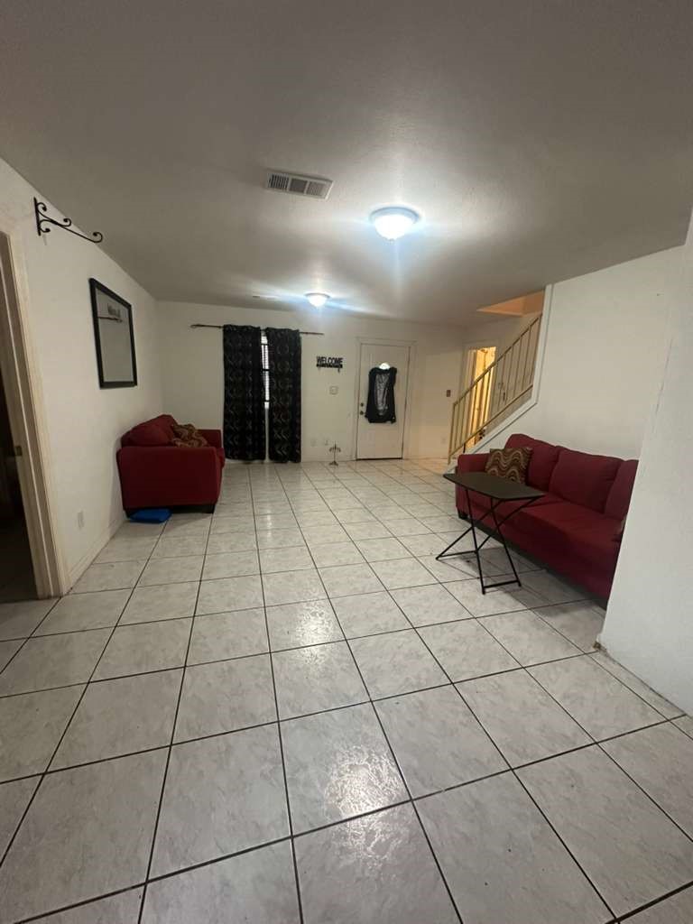 8404 Leander Street Houston, TX 77012 - Photo 5 of 28 a living room with furniture and a mirror