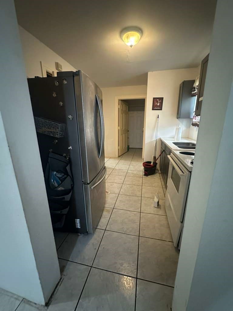 8404 Leander Street Houston, TX 77012 - Photo 9 of 28 a kitchen with stainless steel appliances granite countertop a refrigerator and a stove