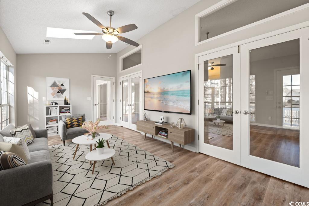 1639 Coventry Road Surfside Beach, SC 29575 - Photo 13 of 38 Living room featuring french doors, ceiling fan, wood-type flooring, and high vaulted ceiling