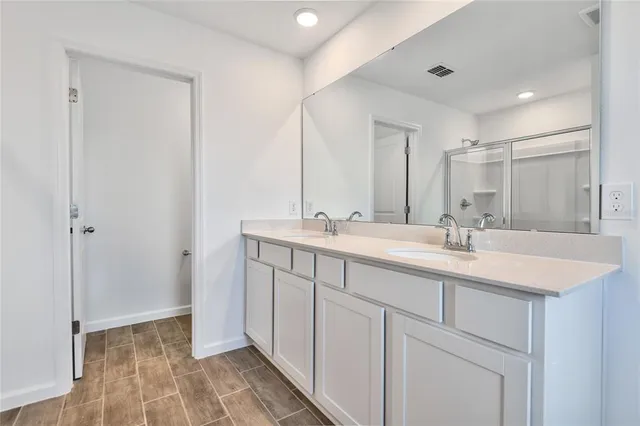 a bathroom with a sink double vanity and a mirror