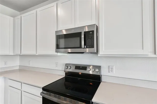 a kitchen with a stove and a microwave