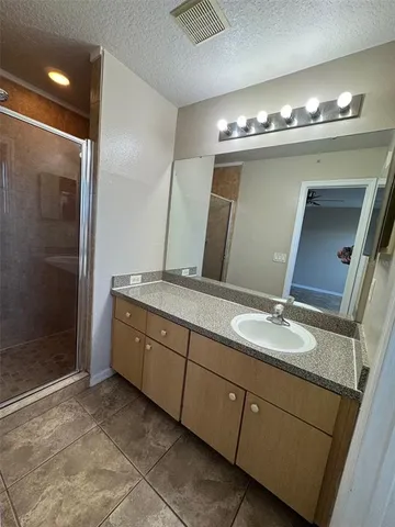 a bathroom with double sink and a mirror