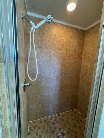 a bathroom with a shower and a sink