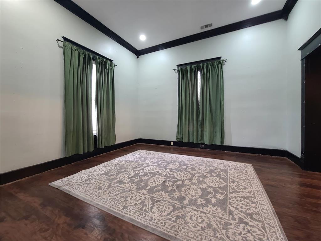 615 West Gandy Street Denison, TX 75020 - Photo 7 of 20 Empty room with crown molding and wood finished floors