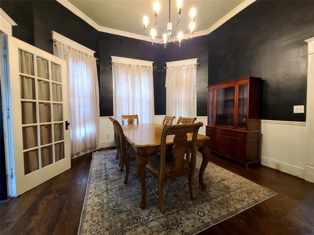 615 West Gandy Street Denison, TX 75020 - Photo 8 of 20 Dining room with a chandelier, wood finished floors, ornamental molding, and wainscoting
