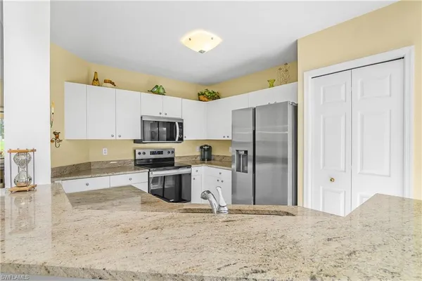 a kitchen with a refrigerator and a sink