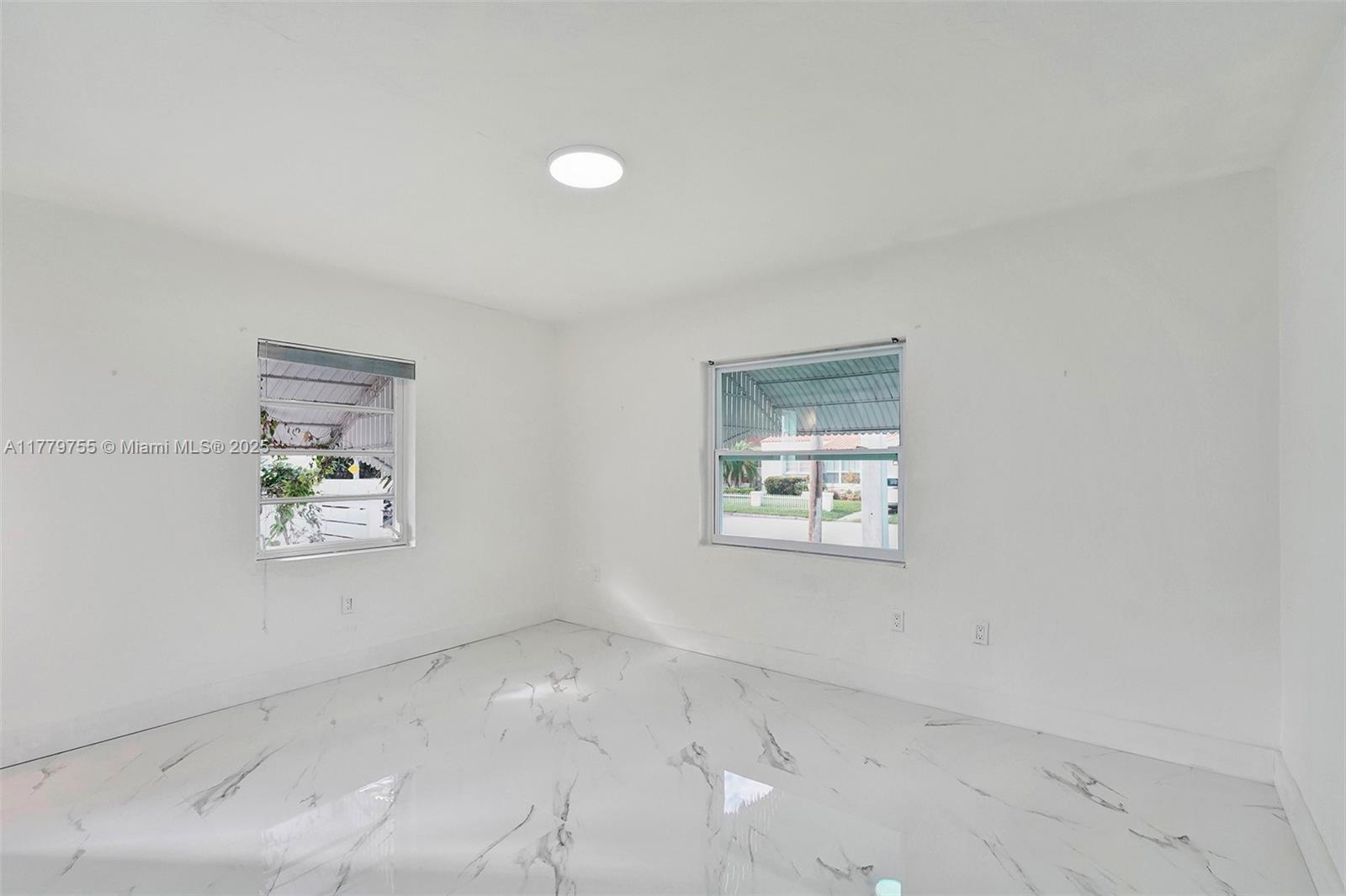 9173 Byron Avenue Surfside, FL 33154 - Photo 2 of 25 an empty room with windows
