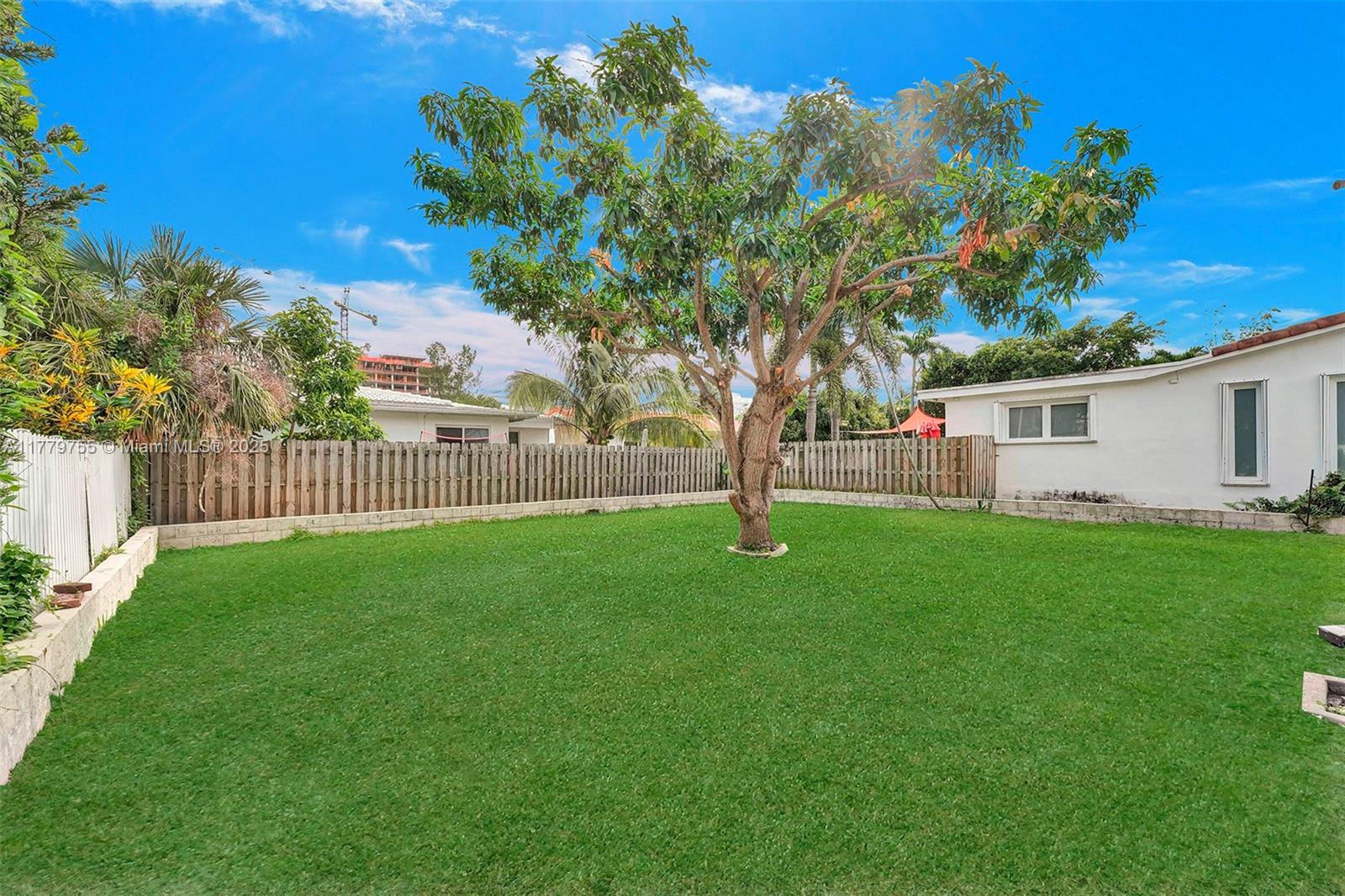 9173 Byron Avenue Surfside, FL 33154 - Photo 23 of 25 a view of a house with backyard and a tree