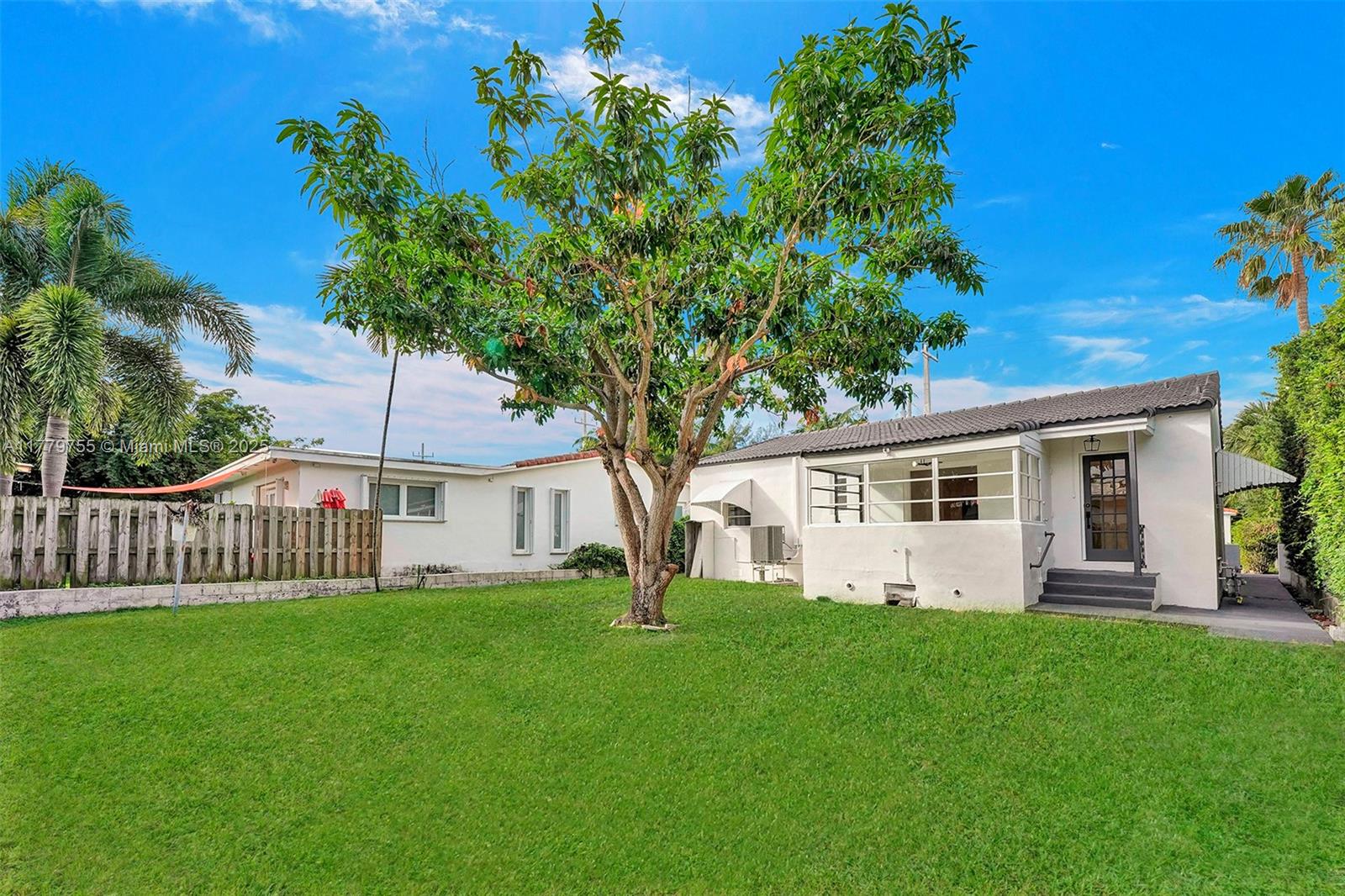 9173 Byron Avenue Surfside, FL 33154 - Photo 24 of 25 a view of a house with backyard and a tree