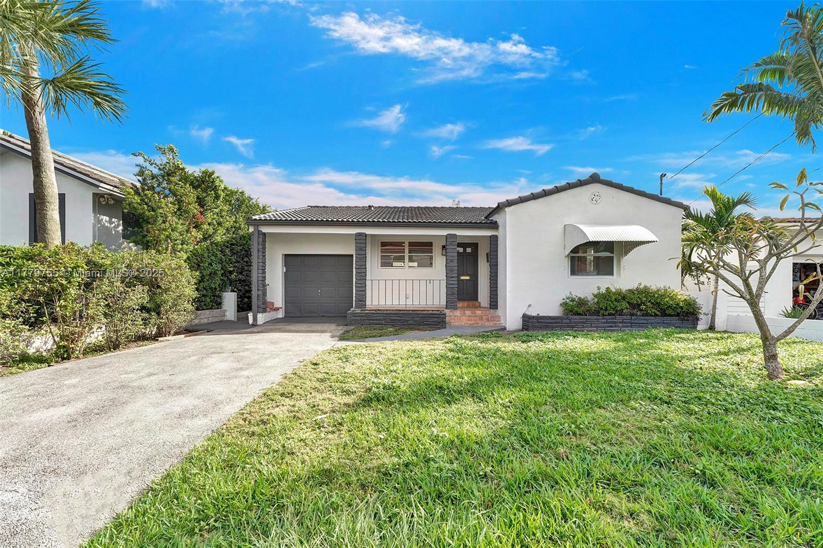 9173 Byron Avenue Surfside, FL 33154 - Photo 25 of 25 a front view of a house with garden