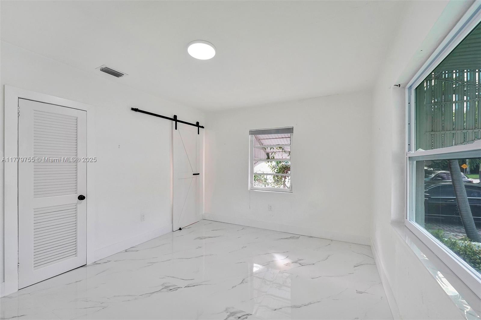 9173 Byron Avenue Surfside, FL 33154 - Photo 3 of 25 a view of an empty room with a window