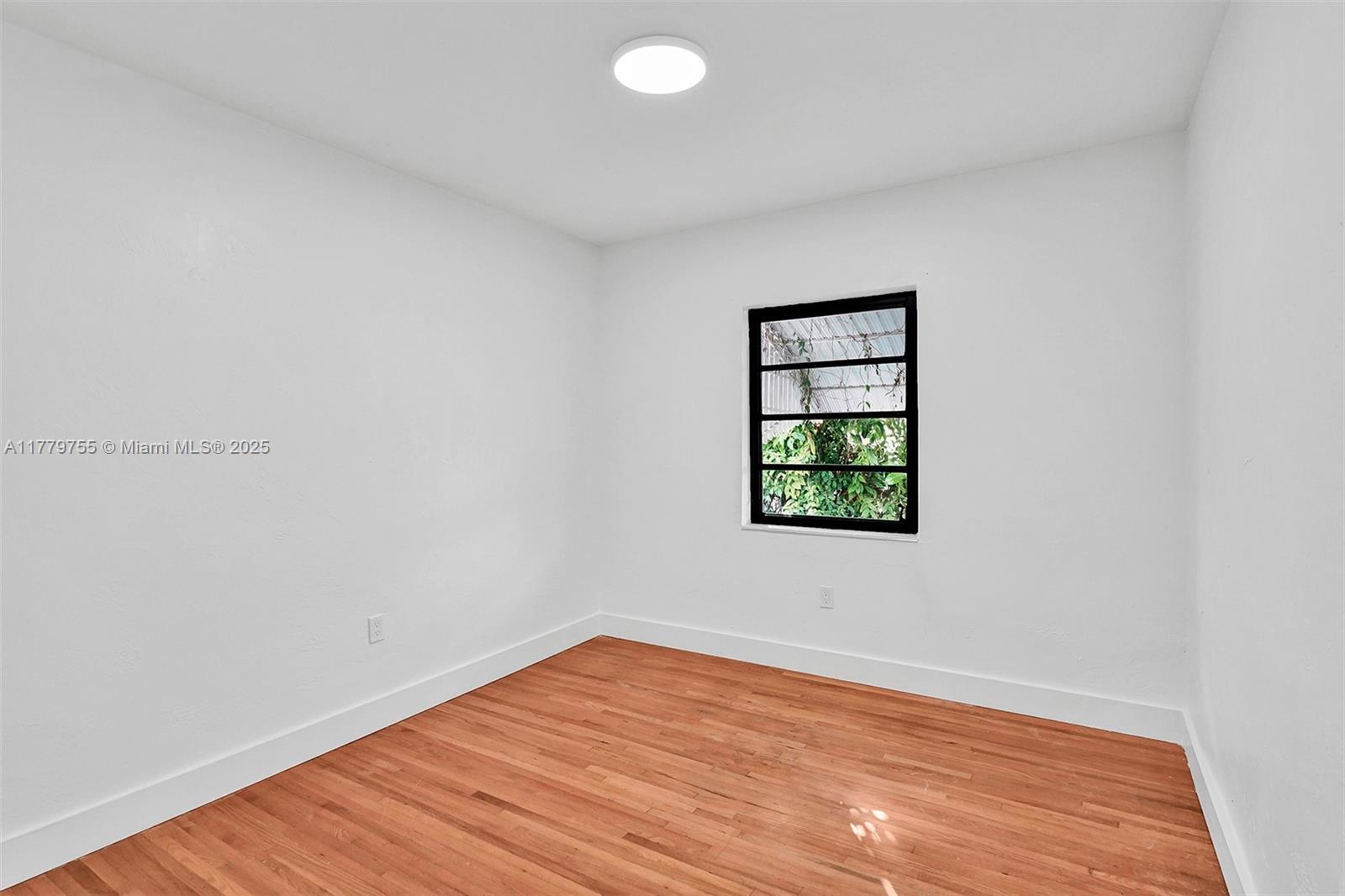 9173 Byron Avenue Surfside, FL 33154 - Photo 7 of 25 an empty room with a window