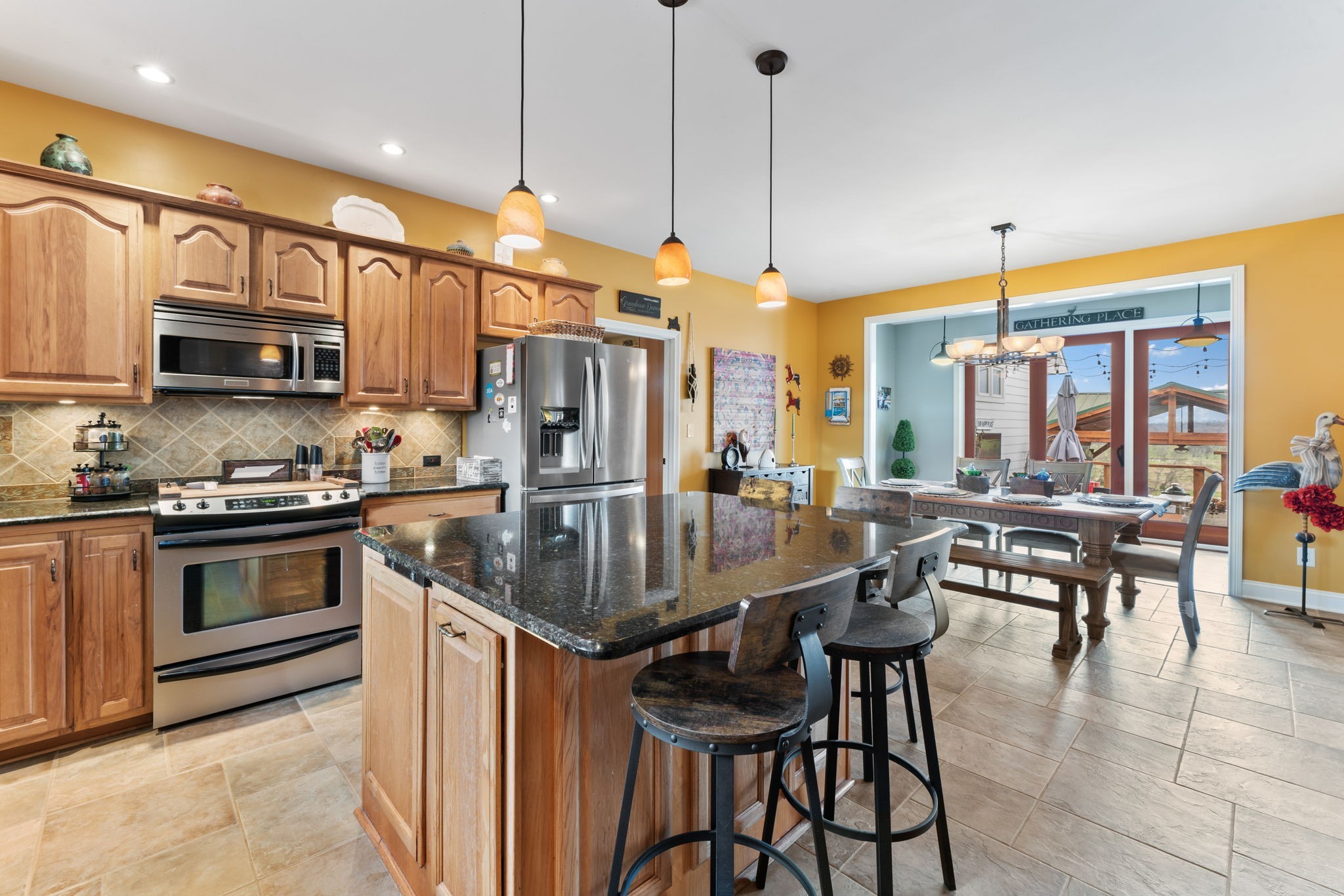 1180 Allisona Road Eagleville, TN 37060 - Photo 24 of 65 a kitchen with stainless steel appliances granite countertop a stove top oven a sink a dining table and chairs with the wooden floor
