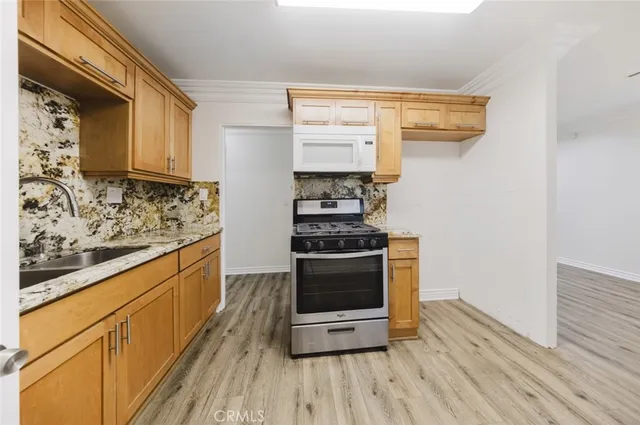 a kitchen with stainless steel appliances a stove and a refrigerator