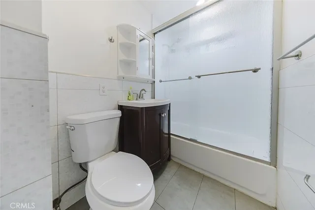 a white toilet sitting next to a bath tub