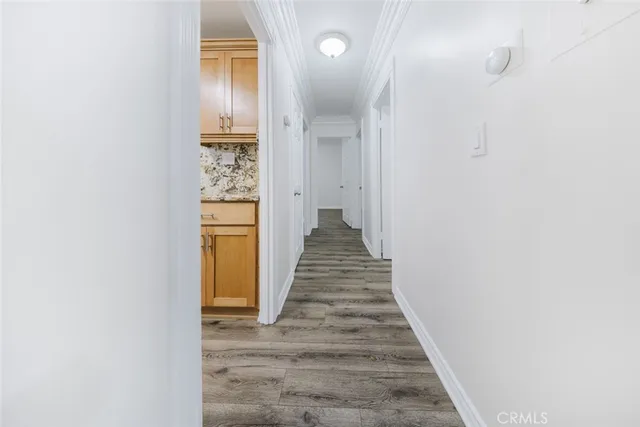 a view of a hallway with wooden floor and staircase