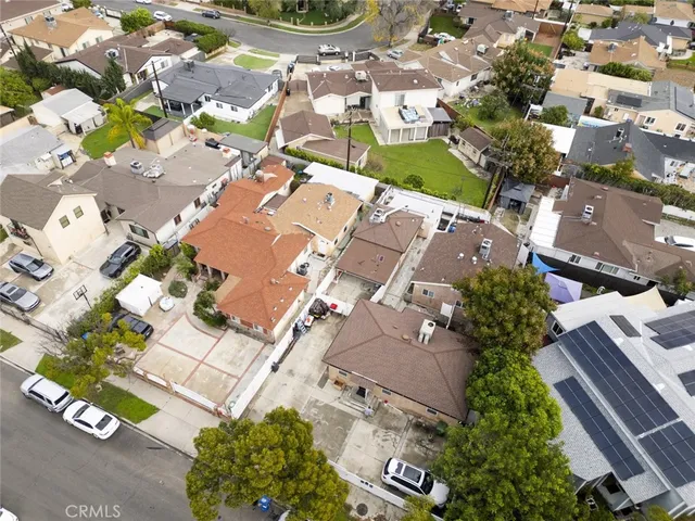 an aerial view of a residential houses with yard