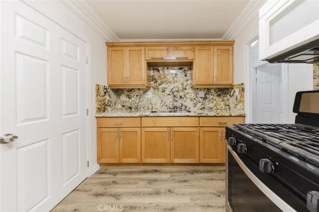 a kitchen with stainless steel appliances granite countertop a stove and a refrigerator