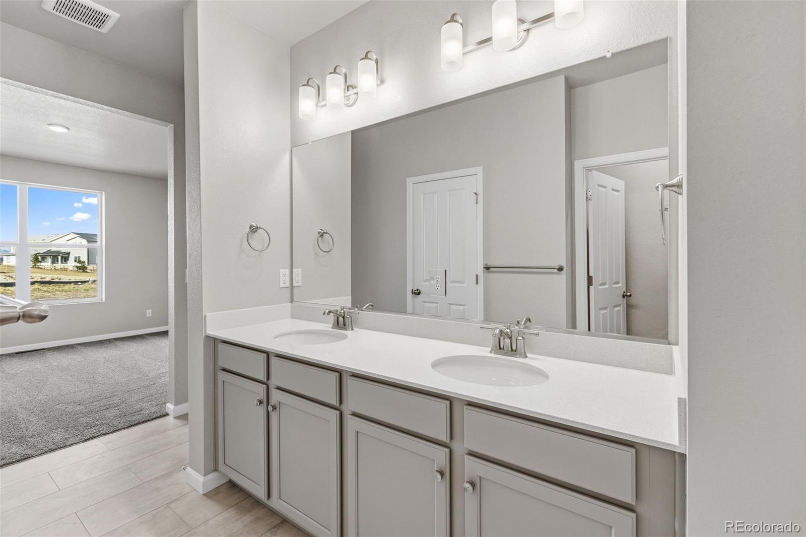 6801 Utica Court Firestone, CO 80504 - Photo 13 of 22 a bathroom with a sink double vanity and a mirror