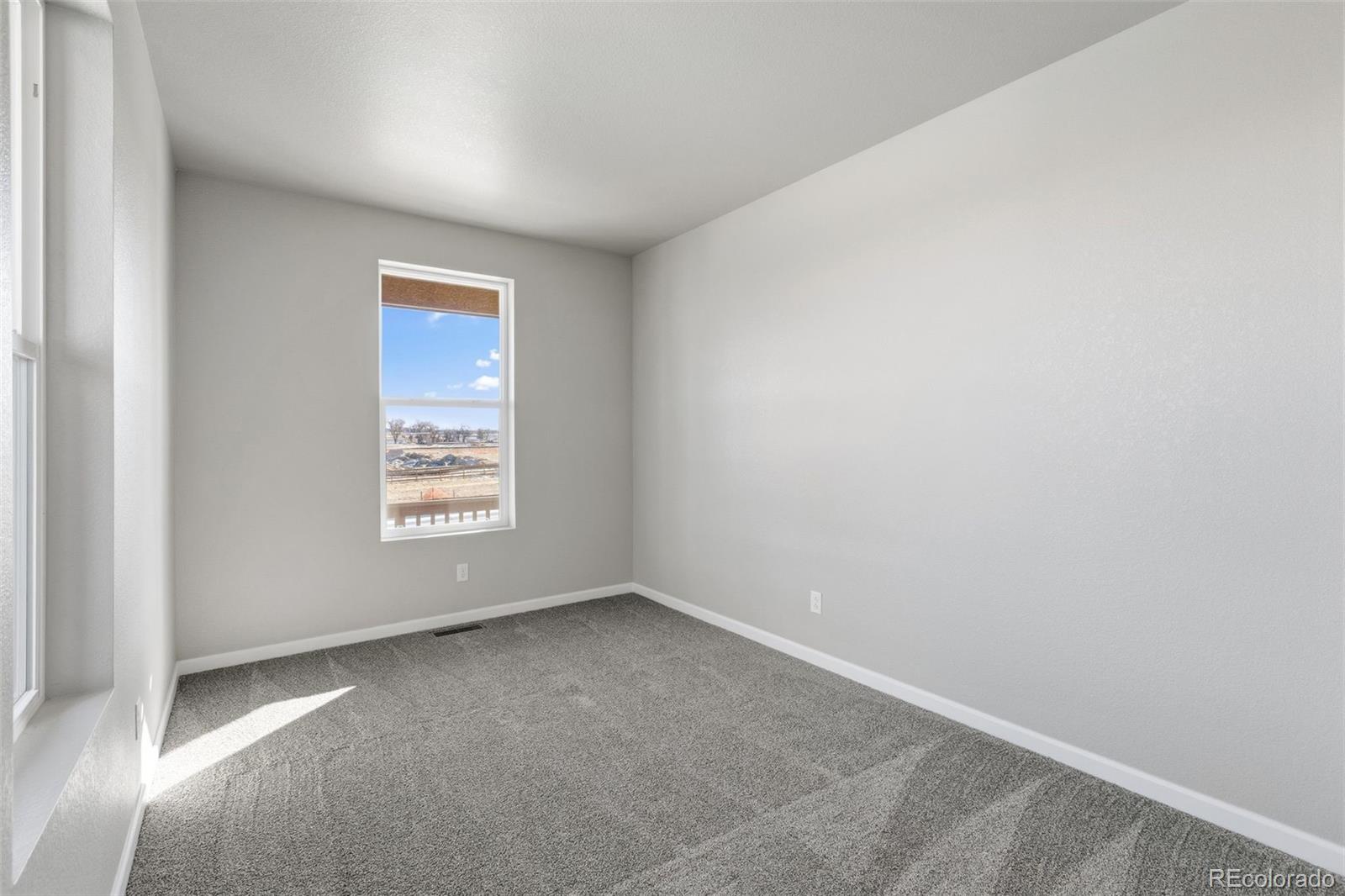 6801 Utica Court Firestone, CO 80504 - Photo 16 of 22 a view of an empty room with a window