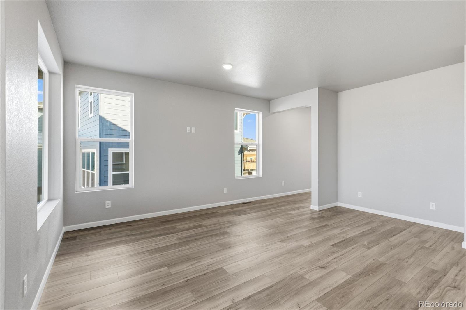 6801 Utica Court Firestone, CO 80504 - Photo 4 of 22 a view of an empty room with wooden floor and a window