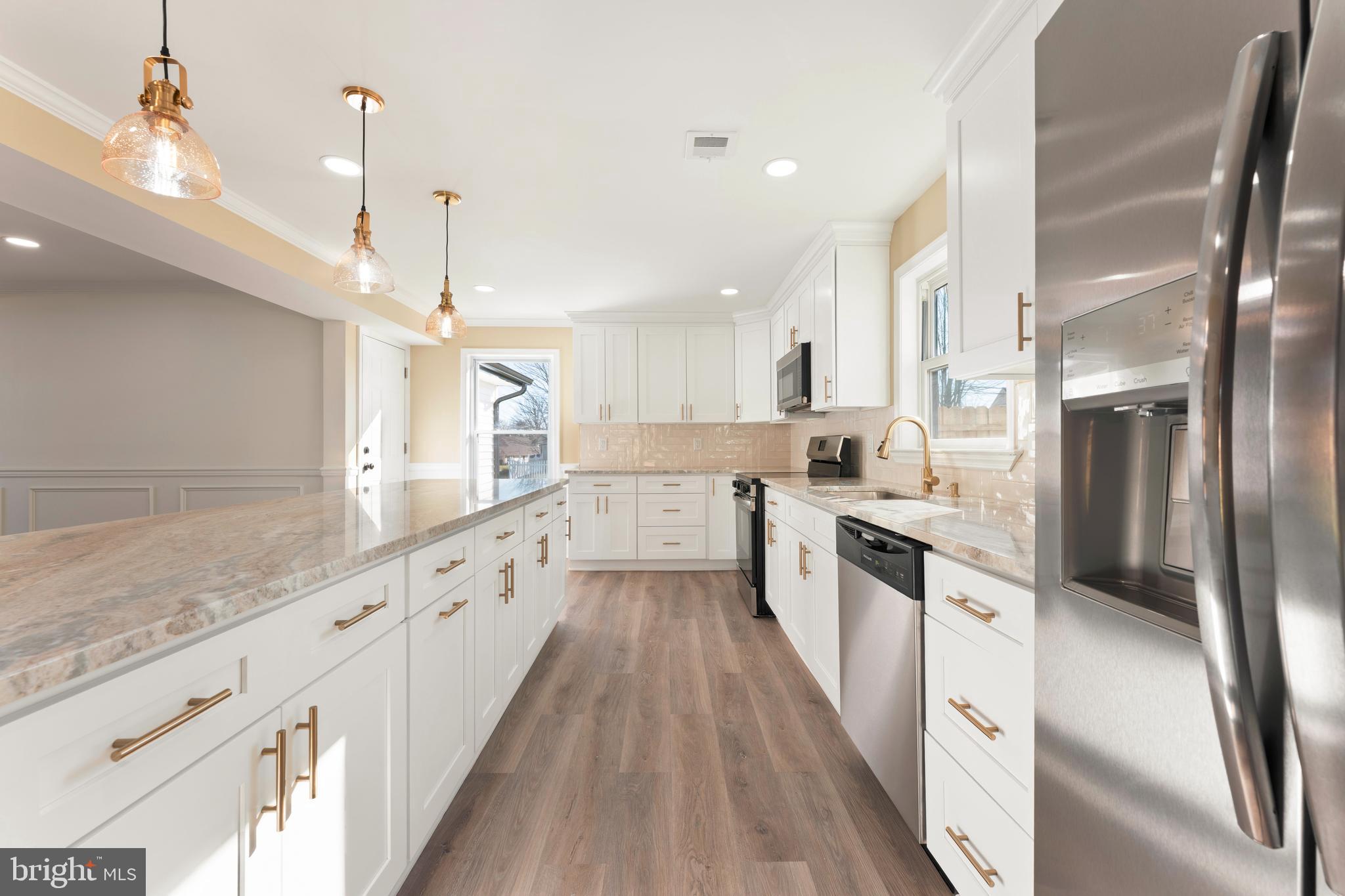 43 Petunia Road Levittown, PA 19056 - Photo 11 of 35 a large kitchen with stainless steel appliances lots of counter space and wooden floor