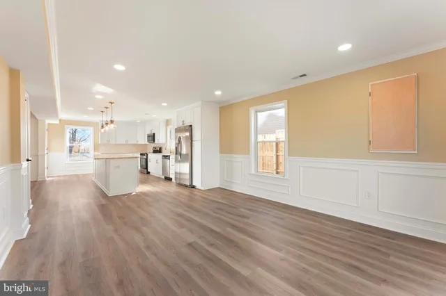 a view of a kitchen with furniture and wooden floor