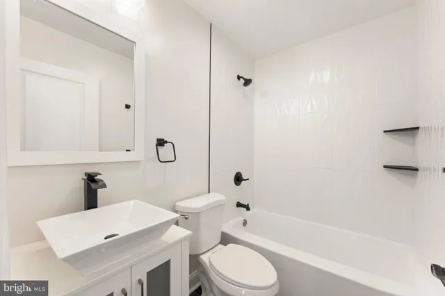 a bathroom with a toilet a sink and bathtub